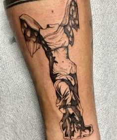 a man's leg with a cross tattoo design on the lower half of his leg