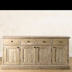 a large wooden cabinet sitting on top of a hard wood floor