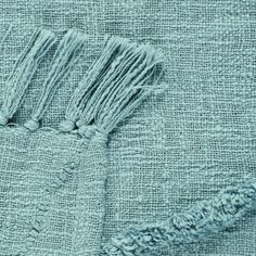 the texture of a blue towel with tassels