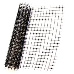 a piece of black wire mesh sitting on top of a white surface with a roll of tape next to it