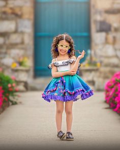 This Mirabel inspired dress is perfect for an encanto birthday or Mirabel costume. it  is all cotton. Features butterfly embroidered flounce with elastic along the shoulders. Sash in front of bodice is embroidered with colorful flowers. Skirt has several layers with ombré print over skirt with velvet trim, pink tassels and ruffle hem. Underskirt is floral print with purple eyelet lace hem. Full petticoat sewn into dress. Bottommost layer had a folded up you can pull apart to fully voluminize the skirt. Dress is fully lined with fully lined bloomers.  This is a pre order shipping mid July Mirabel Encanto Costume, Unique Kids Halloween Costume, Mirabel Costume, Encanto Costume, Encanto Dress, Encanto Birthday, Encanto Party, Disney Dress Up, Disney 2024