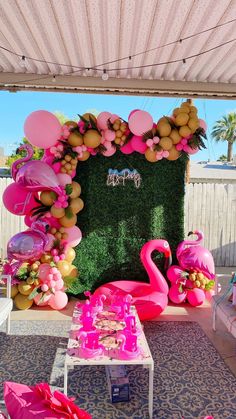 a pink flamingo themed party with balloons and decorations