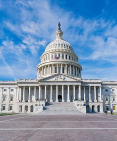 the united states capitol building in washington d c on a sunny day with blue skies