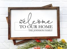 a sign that says, welcome to our home the johnson family with flowers around it