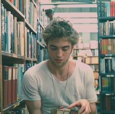 a young man reading a book in a library with a quote from the author on it