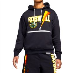 In The Early 2000's, The Roswell Rayguns Invaded The Airwaves In A Series Of Nike Basketball Commercials. Join The Fan-Favorite Fictional Team With The Nike Dri-Fit Rayguns Men's Premium Basketball Hoodie. Screen-Printed And Sequined Graphics Pay Homage To The Invasion! The Heavyweight French Terry Fabric Combines The Softness Of Cotton With The Durability Of Polyester. Zippered Pocket. Body: 61% Cotton/39% Recycled Polyester. Rib: 97% Cotton/3% Spandex. Hood Lining: 100% Cotton. Smoke Free Home Nike Hoodie For Streetwear During Sports Season, Nike Hoodie For Streetwear During Sports Events, Nike Hoodie For Sports Season Streetwear, Nike Collegiate Hoodie For Streetwear, Nike Varsity Sweatshirt For Streetwear, Nike Cotton Hoodie With Graphic Print, Nike Sporty Hoodie With Graphic Print, Nike Tech Sweatsuit, Nike Compression