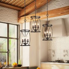 three lights hanging from the ceiling in a kitchen