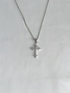 A versatile necklace featuring a sparkling cross charm on a 2mm rolo chain, resistant to tarnishing. The perfect addition to any jewelry collection. Our chains are 100% stainless steel and hypoallergenic so they won't rust, tarnish, or turn your neck green. - Pendant size: ~25mm - Sterling silver pendant - Will not rust or tarnish - Lobster clasp closure - Select desired size at checkout Silver Tarnish Resistant Cross Necklace Gift, Silver Tarnish Resistant Cross Necklace For Gift, Silver Tarnish-resistant Cross Necklace For Gift, Silver Jewlery, Present Birthday, Cz Necklace, Diamond Cross, Birthday Gift For Her, Cross Charms