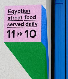 the egyptian street food served daily is displayed on a building's exterior painted white and blue