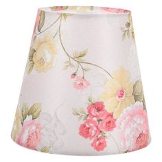 a white lamp shade with pink and yellow flowers on it