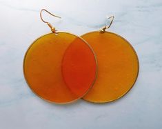 Yellow Earrings, Transparent Earrings, Circle EarringsThe earrings are like the Yellow Sea or 黃海 located between China and Korea. Its name comes from the sand particles from Gobi Desert sand storms that turn the surface of the water golden yellow.These earrings signal warmth, agility, freshness, happiness, joy of life, vitality. Enjoy. Trendy Orange Round Earrings, Orange Round Earrings For Summer, Orange Circular Earrings For Gift, Orange Circle Earrings For Gift, Handmade Orange Circular Earrings, Transparent Earrings, Sand Particles, Gobi Desert, Yellow Sea