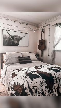 a bed room with a neatly made bed and a guitar hanging on the wall above it