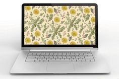 an open laptop computer sitting on top of a white table next to a plant and butterfly wallpaper