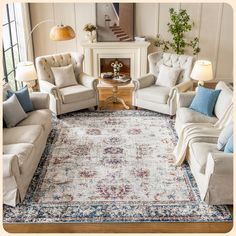 a living room with couches, chairs and a rug on the floor in front of a fireplace