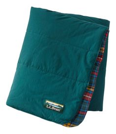 a green pillow with a plaid lining on the front and back of it's cover