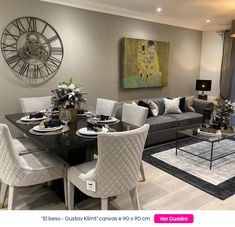 a living room filled with furniture and a large clock on the wall above it's windows