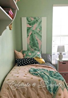 a bed room with a neatly made bed and green walls