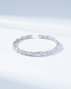 Elevate your wristwear with the Classic Diamond Sparkler Bangle, a testament to Suzanne Kalan's signature craftsmanship. This exquisite bangle, is set in luxurious 18k gold and boasts 1.20 carats of meticulously arranged baguette-cut diamonds, interspersed with 0.33 carats of brilliant round-cut diamonds. Each diamond is handpicked for its exceptional clarity and color, ensuring that the bangle shimmers with an unmatched sparkle. Designed to be both timeless and striking, the Sparkler Bangle is Fine Jewelry White Gold Bangle With Baguette Diamonds, Elegant White Gold Bangle With Baguette Diamonds, White Gold Bangle With Baguette Diamonds, Elegant Diamond Bangle With Baguette Diamonds, Elegant Cubic Zirconia Bangle With Baguette Diamonds, Elegant Baguette Diamond Bangle For Formal Events, Elegant Baguette Diamond Bangle, Luxury Baguette Diamond Bangle For Formal Events, Elegant Baguette Cut Bangle