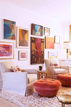 a living room filled with furniture and pictures on the wall