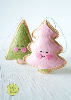 three felt christmas trees with faces on them