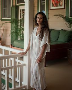 A sheer natural white caftan dress detailed with a deep V-shaped neckline, wide armhole with kimono sleeves, and side slits on both sides. This elegant jamdani cotton cover-up is ideal for tropical destinations and resort wear. It is crafted from sustainable material, handspun by local women weavers of India. - Length: 47” - Fabric: Cotton blend silk - Color: Natural white Festive White V-neck Kaftan, Luxury V-neck Kaftan For Beach Cover-up, White V-neck Kaftan For Daywear, White V-neck Kaftan For Beach, Chic White V-neck Kaftan, Tropical Destinations, Caftan Dress, Kimono Sleeve, Resort Wear