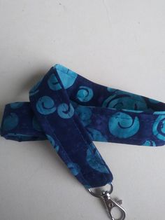 "Blue and dark blue lanyard. This listing is for ONE lanyard! Handmade by me with 100% cotton fabric measuring approximately 40-42 inches around(20\"-21\" Drop when placed around neck) and 3/4 inch wide. A key ring and a swivel clasp/hook are attached to the lanyard. Lanyards can be used for functional purposes such as I.D. wearing and attaching to keys for easy around-the-neck-wearing. This one would make an awesome gift. Hand washing recommended for lanyard, lay flat to dry. Thank You for shop Blue Lanyard With Key Leash For Gift, Blue Lanyard With Key Leash As Gift, Blue Lanyards With Key Leash As Gift, Handmade Blue Lanyards For Gifts, Handmade Blue Lanyards As Gifts, Handmade Blue Lanyard As Gift, Lanyard Blue, Keychain Lanyard, Badge Lanyard