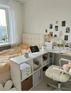 a bed room with a neatly made bed and a desk in front of a window