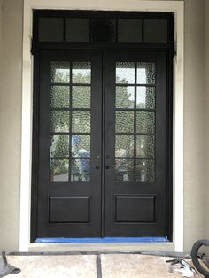 the front door is painted black and has glass panels