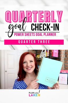 a woman holding up a notebook with the words quarterly goal check - in