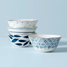 three bowls with blue designs on them sitting side by side in front of a light blue background