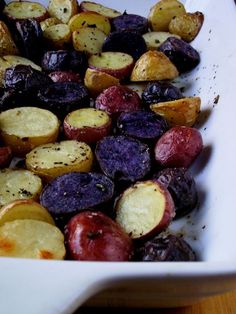 potatoes and plums in a white dish with seasoning on the side, ready to be eaten