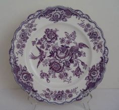 a purple and white plate with flowers on it