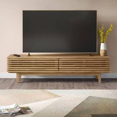 a wooden entertainment center with a flat screen tv mounted on it's sideboard