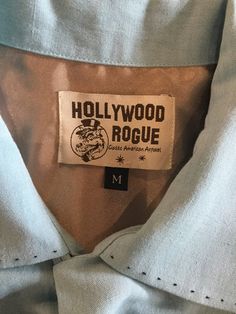 "1950s vintage reproduction Hollywood Rogue two tone shark gill shirt with hand finished top stitching. The linen shirt has a loop collar, one patch pocket and a five button down front. The shirt is a aqua blue with constrasting black on front panels and pockets. The shirt features top stitching on the collar, down both sides of patch pocket and on shark gill design on right side of chest panel. This shirt as with all clothing made by \"Hollywood Rogue\" was made in very limited numbers. The shi Vintage Linen Shirt With Buttons, Vintage Linen Shirt With Pockets, Vintage Linen Shirt With Button Closure, Vintage Collared Linen Shirt, Vintage Linen Collared Shirt, Usa Shirt, Aloha Shirt, 1950s Vintage, Long Beach