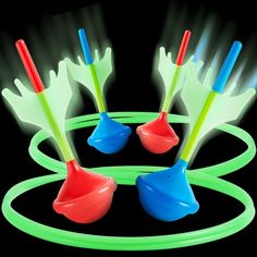 glow in the dark toys on a black background with green and red rings around them