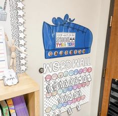 a bulletin board on the side of a wall next to a wooden table with scissors