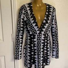 a mannequin wearing a black and white patterned jacket on top of a dummy