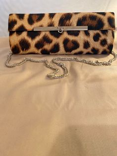 Beautiful clutch bag with a detachable chrome chain, a small inside pocket for credit cards, plenty of room for a mobile phone, keys, small makeup kit, lipstick and money. This bag is designed by British fashion designer Shakeel Rabbaney using a typical Animal print pattern with sleek chrome clasp. All our bags are limited edition with a maximum of ten made in each pattern. Elegant Rectangular Wallet As Fashion Accessory, Elegant Rectangular Fashion Wallet, Elegant Handheld Bag With Card Slots, Evening Crossbody Bag With Card Slots, Chic Evening Wallet With Mobile Phone Bag, Formal Mobile Phone Pouch Clutch, Formal Rectangular Wallet On Chain With Phone Bag, Chic Bags With Card Slots, Chic Rectangular Case Bag With Card Slots