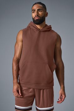 Stay cozy without sacrificing style in the Renown Sleeveless Hoodie. It has deep armholes, a kangaroo pocket, and a laid-back cut. And wait till you feel the Alo signature Renown fabric—it's smooth on the outside, a little fleecy on the side, and heavyweight for a just-right drape. Add shorts and you’re covered from the gym to the street. Brown Sleeveless Sports Top, Casual Brown Stretch Vest, Alo Yoga Hooded Top With Drawstring Hood, Fall Gym Tops With Pockets, Sleeveless Alo Yoga Activewear For Gym, Sleeveless Alo Yoga Athleisure Top, Alo Yoga Sporty Sleeveless Top, Alo Yoga Sleeveless Athleisure Top, Alo Yoga Sleeveless Activewear For Gym