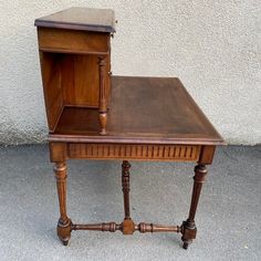 an old wooden desk with a shelf on top