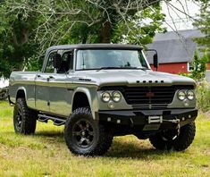 an old pick up truck is parked in the grass