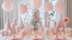 a table set for christmas with pink decorations