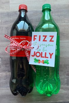 two bottled sodas with a red ribbon tied around the top one is green and the other is black