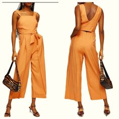 Sleeveless Wide Leg Jumpsuit By Topshop Is New With Tags! Dress It Up With Your Favorite Handbag & Heels Or Go Casual With A Straw Hat & Flip Flops!! Pale Apricot With Off White Lining Sleeveless Jumpsuit Has Squared Neckline, Cross Over Wrap V Back, Tie Waist, Cut Out Lower Back, Dual Slide Hip Pockets With Button Closure & Wide Legs Concealed Zipper Closure Shell: Viscose/Polyester Lining: Polyester/Cotton Size 6 (See Photo Of Measurements) No Flaws Or Damage 2628 New, Jumpsuit, Spring, Summer Spring Sleeveless Jumpsuits And Rompers With Tie Straps, Summer Sleeveless Jumpsuits And Rompers With Pockets, Sleeveless Summer Jumpsuits And Rompers With Pockets, Sleeveless Jumpsuit With Adjustable Straps For Spring, High Waist Jumpsuits And Rompers For Summer Workwear, Summer Sleeveless Jumpsuits With Tie Straps, Summer Sleeveless Jumpsuits And Rompers With Tie Straps, Summer Orange Cotton Jumpsuits And Rompers, Fitted Sleeveless Jumpsuit With Tie Straps