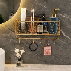 a bathroom sink with a gold shelf and soap dispenser next to it