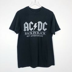 Ac/Dc Official Back In Black T-Shirt - Medium - Ultra Soft, High End Jersey - Official Ac/Dc Merchandise - Back In Black' 40th Anniversary Collection Please Contact Me With Any Questions! Rock Style Cotton T-shirt With Logo Print, Black Short Sleeve Tops With Band Logo, Black Short Sleeve Top With Band Logo, Rock Style Band Logo T-shirt With Crew Neck, Black Band Merch T-shirt With Logo, Black Band Logo Crew Neck Top, Rock Style T-shirt With Logo For Concerts, Black Logo Print Top For Concert, Black Crew Neck Tops With Band Logo