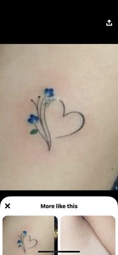 the back of a woman's stomach with blue flowers on it and an arrow in the shape of a heart