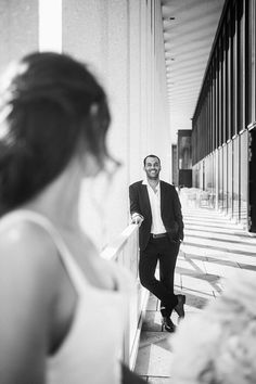 a man in a suit leaning against a wall