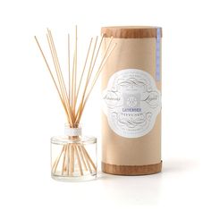 the reed sticks are next to an empty bottle with a label on it that says,