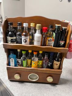 an old wooden spice rack filled with liquor bottles